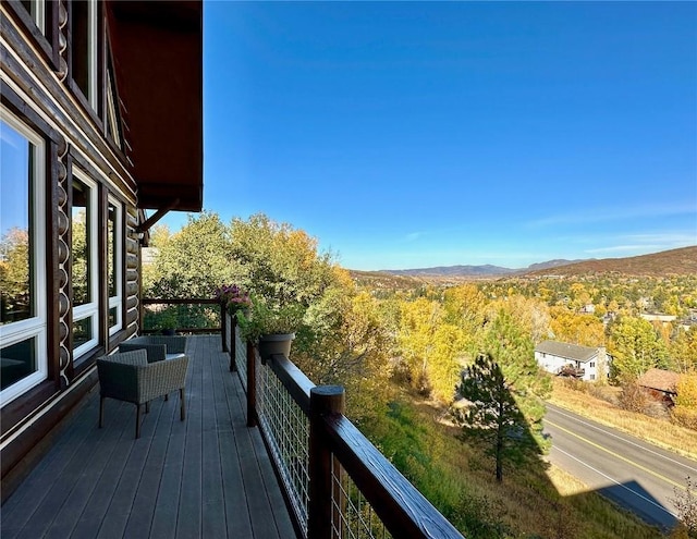 wooden deck with a mountain view