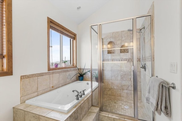 bathroom with shower with separate bathtub and vaulted ceiling