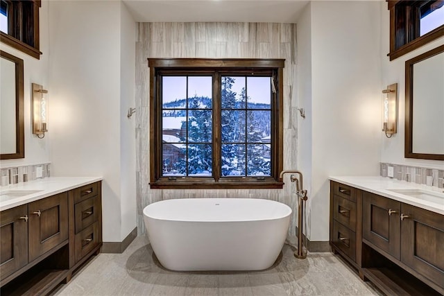 bathroom with vanity, a bath, and backsplash