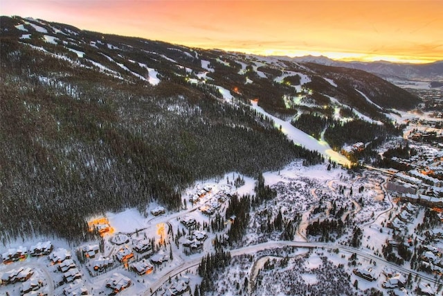 snowy aerial view featuring a mountain view