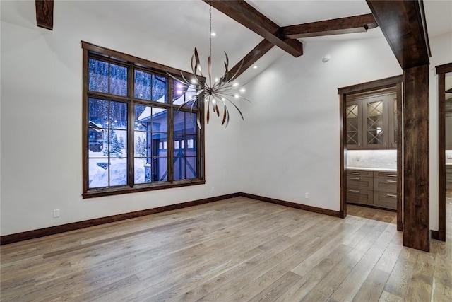 unfurnished dining area featuring lofted ceiling with beams, a chandelier, and light wood-type flooring