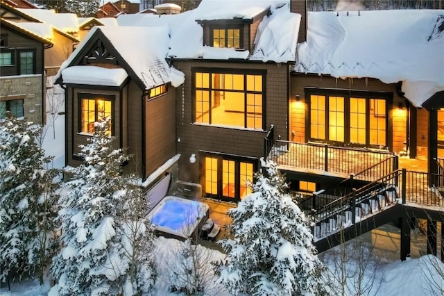 view of snow covered back of property