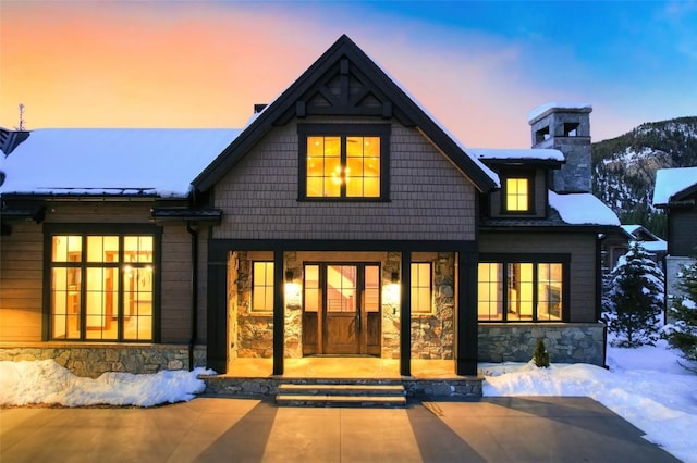 view of snow covered back of property