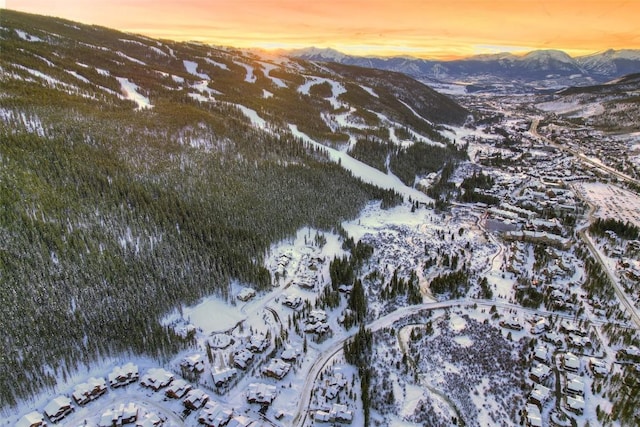 snowy aerial view featuring a mountain view