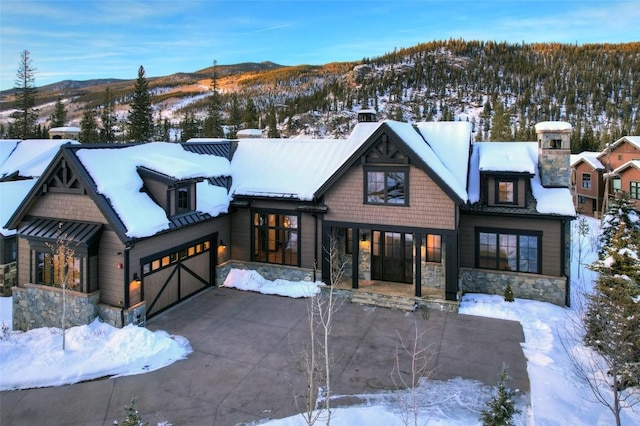 view of front of home with a garage and a mountain view