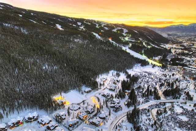 snowy aerial view featuring a mountain view