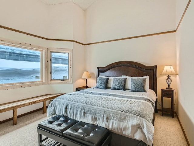 bedroom featuring high vaulted ceiling and baseboards