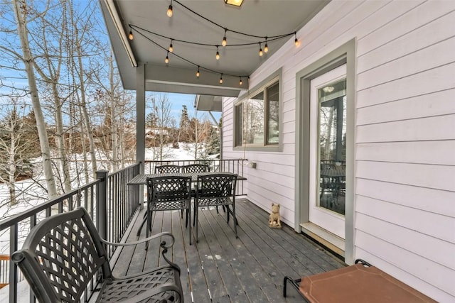 snow covered deck with outdoor dining area