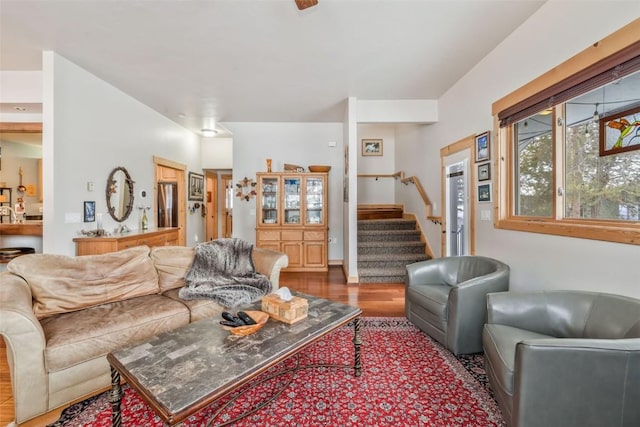 living area with stairway and wood finished floors