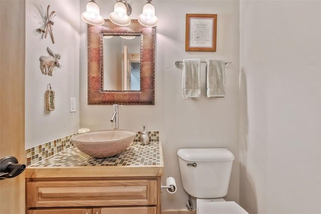 half bathroom with vanity and toilet