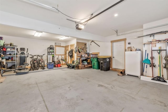 garage with a workshop area and freestanding refrigerator