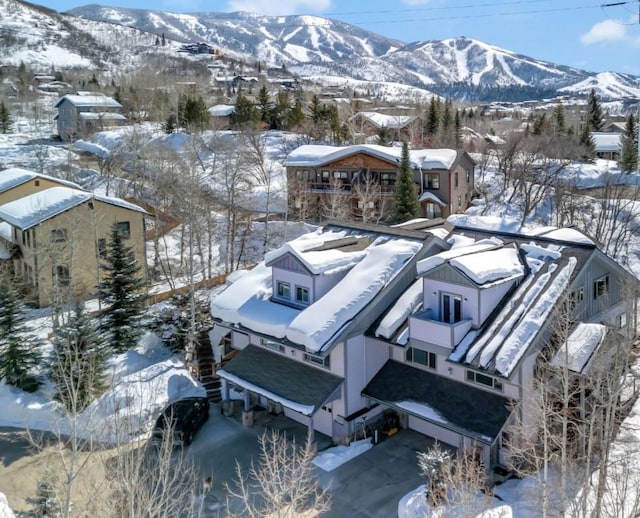 snowy aerial view with a mountain view