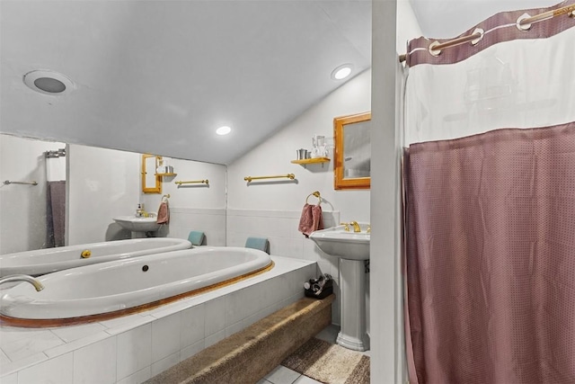 bathroom featuring tile patterned flooring, shower with separate bathtub, lofted ceiling, and sink