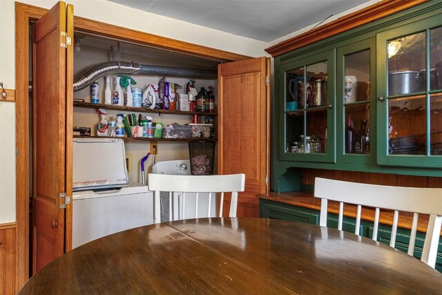 laundry area with wood walls and independent washer and dryer