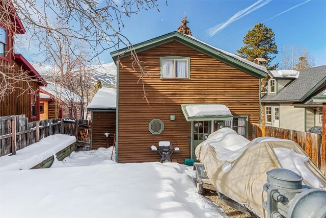 view of snow covered rear of property