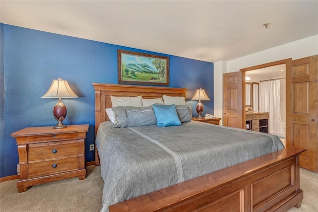 bedroom with light colored carpet and baseboards