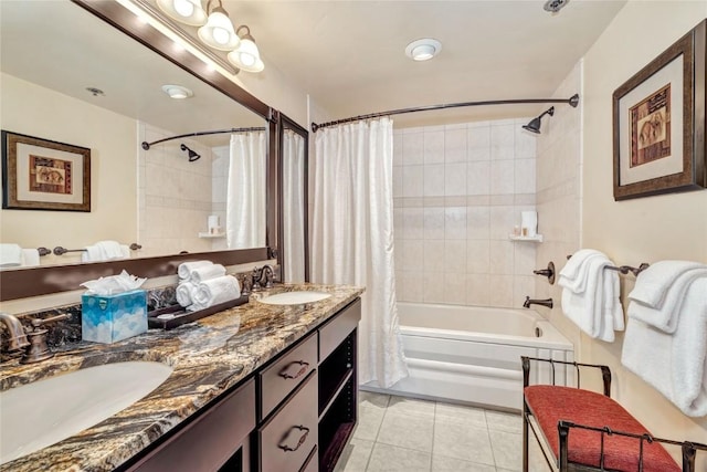 full bath featuring tile patterned floors, double vanity, shower / bath combo, and a sink