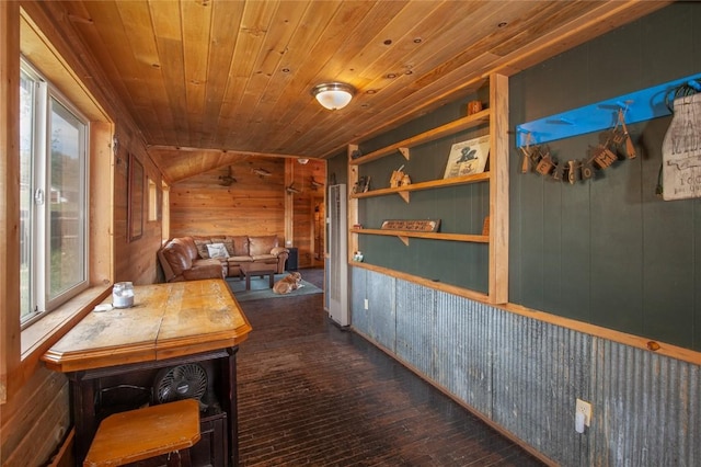 corridor featuring lofted ceiling, wood walls, wooden ceiling, and dark hardwood / wood-style floors