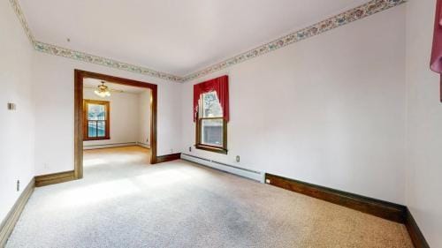 unfurnished room featuring carpet flooring, baseboards, and baseboard heating