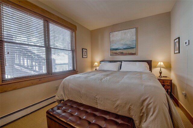 carpeted bedroom with a baseboard radiator