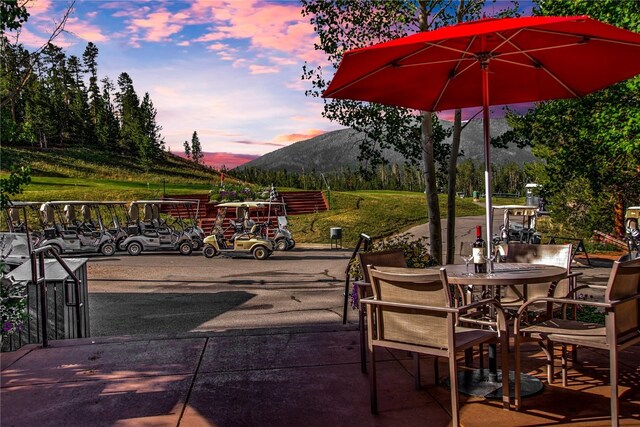 view of patio with a mountain view and outdoor dining area