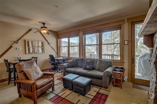 living room with light carpet, ceiling fan, and baseboards