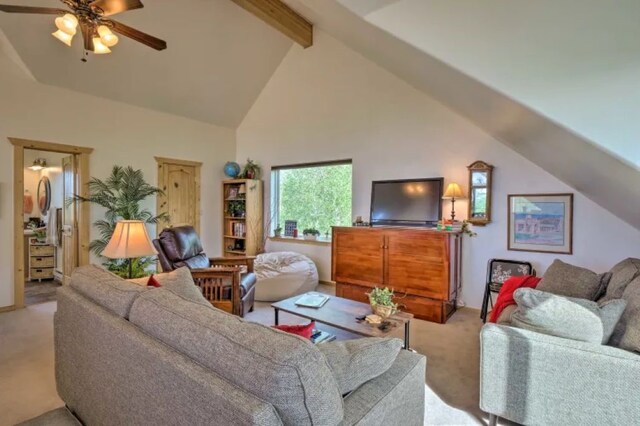 carpeted living room featuring beam ceiling, high vaulted ceiling, and ceiling fan