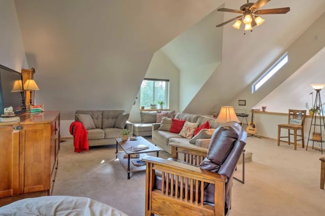 living room featuring lofted ceiling with skylight, ceiling fan, and light carpet