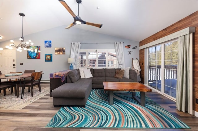 living room featuring ceiling fan with notable chandelier, lofted ceiling, and hardwood / wood-style floors