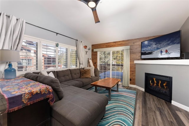 living room featuring vaulted ceiling, dark hardwood / wood-style floors, and wooden walls