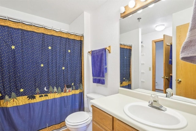 bathroom featuring a shower with curtain, vanity, and toilet