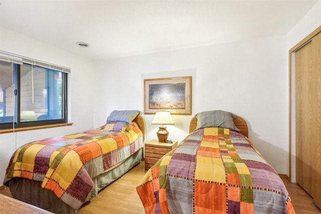 bedroom featuring a closet and light wood-type flooring