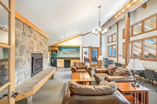 living room with a fireplace, carpet floors, lofted ceiling with beams, and a notable chandelier