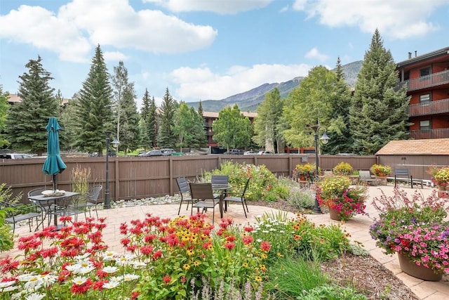 surrounding community featuring a mountain view and a patio