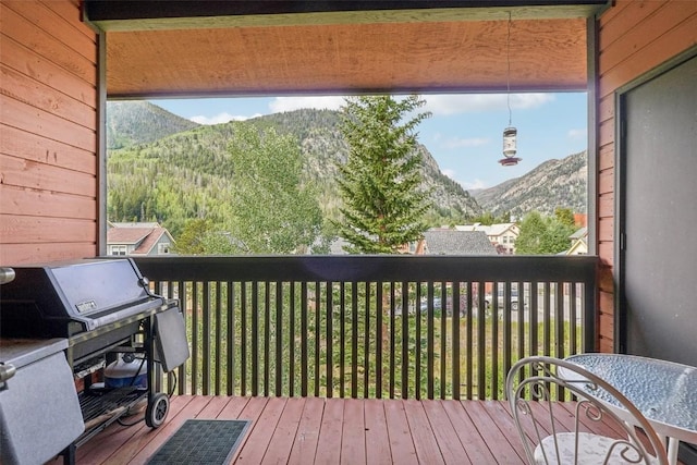 wooden terrace featuring grilling area and a mountain view