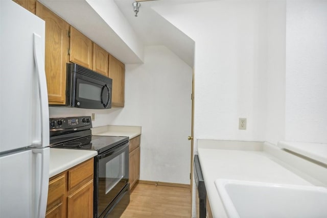 kitchen with black appliances and light wood-type flooring