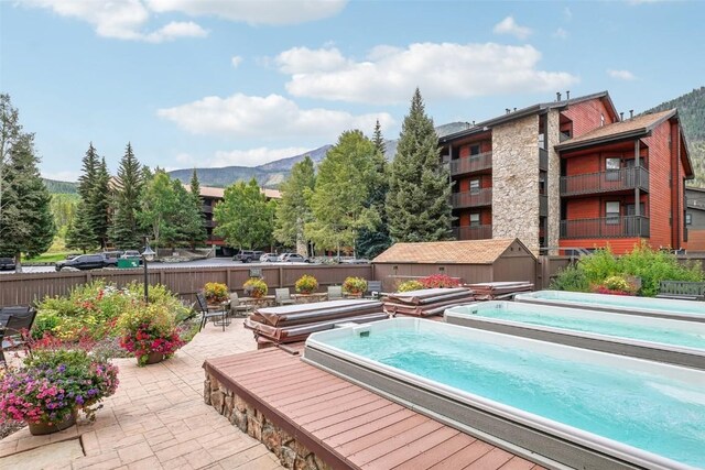 view of pool with a patio area and a mountain view