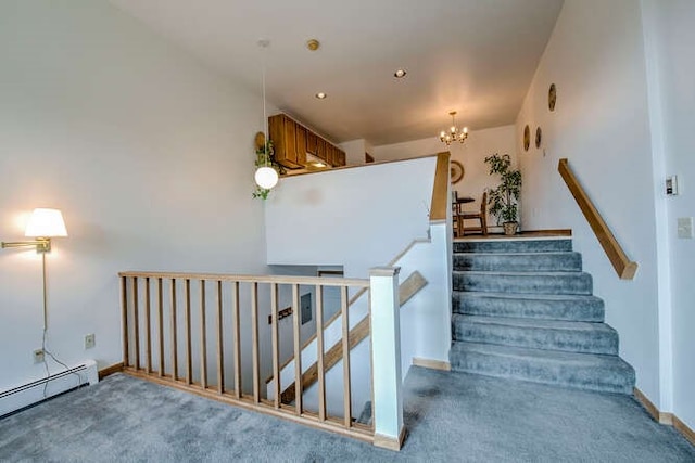 staircase with a baseboard heating unit, carpet floors, baseboards, and a notable chandelier