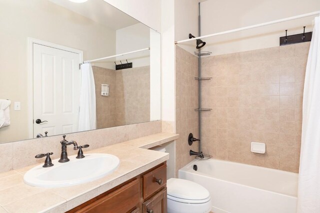 full bathroom featuring vanity, toilet, and shower / tub combo with curtain