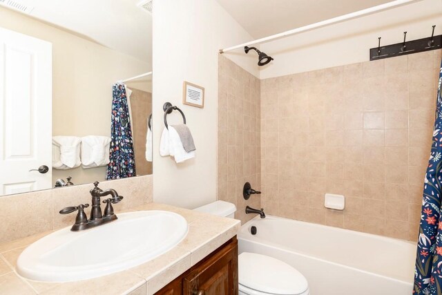 full bathroom featuring shower / bath combo with shower curtain, vanity, and toilet