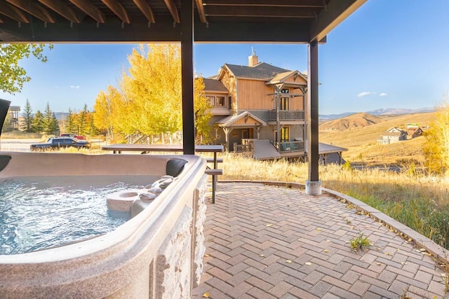 view of patio / terrace featuring a mountain view and a balcony