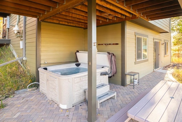 wooden deck with a patio and a hot tub