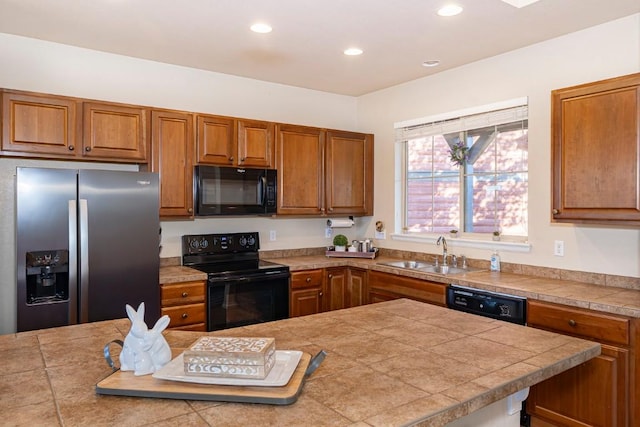 kitchen featuring black appliances, tile counters, and sink