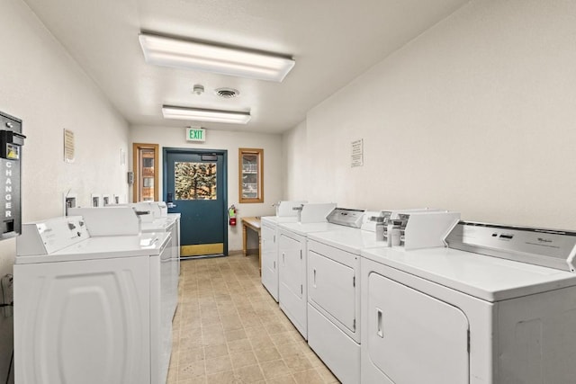 community laundry room with washer and dryer and visible vents