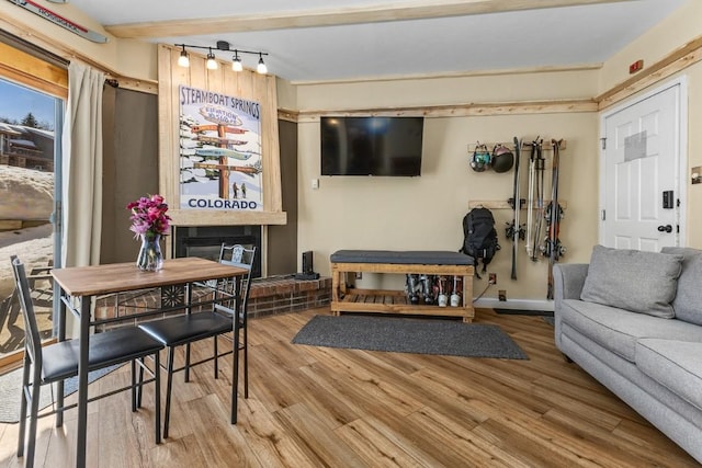 living area featuring baseboards and wood finished floors