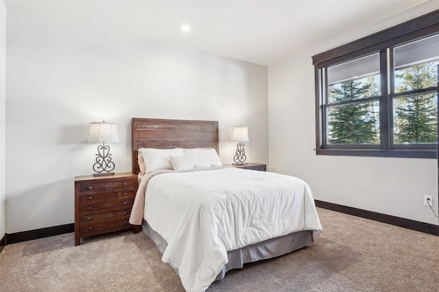 bedroom with recessed lighting, light colored carpet, and baseboards