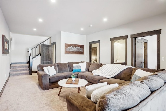 living area with recessed lighting, stairway, light colored carpet, and baseboards