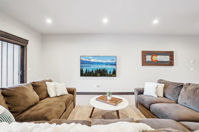 living area featuring recessed lighting and carpet