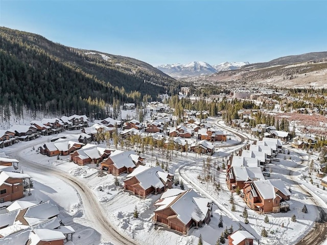 snowy aerial view with a mountain view