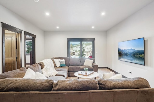 living area featuring recessed lighting, a healthy amount of sunlight, carpet, and baseboards